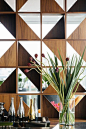 Love this combination wall panelling with Elm and Walnut triangles combined with mirrored triangles.