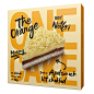 an orange cake with white frosting on it's side in a cardboard box