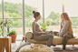 Pregnant women drinking tea and talking in living room by Caia Images on 500px