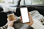 woman-holding-blank-phone-cup-coffee