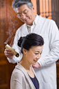 Senior Chinese doctor giving moxibustion by blue_jean_images on 500px