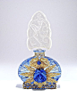 1920s Czechoslovakian perfume bottle, blue crystal, clear intaglio stopper, jeweled gilt metalwork. Czechoslovakia in line, and on metal.
6 3/4 in.