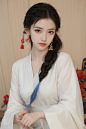  1girl, solo, long hair, （looking at viewer:1.6), smile, simple background, black hair, hair ornament, jewelry, closed mouth,earrings, makeup, chinese clothes, red lips, tassel earrings, hanfu, realistic，Look at the camera,Full-length portrait,