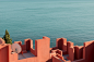 LA MURALLA ROJA : La Muralla Roja, by Ricardo Bofill, is certainly a paradise for photographers. Located in Calpe, Spain, the building makes clear references to the Arab Mediterranean culture. Formed like a fortress, the complex emerges from the cliffs it