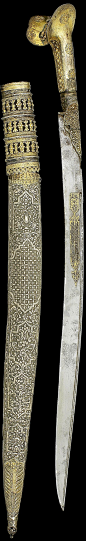 Ottoman yatagan, 19th c, gold inlaid blade, silver-gilt grip and scabbard with filigree rosettes to sides and pommel, repousse silver scabbard with cartouches on a floral ground, gilded terminal and upper, 74.5cm. Inscribed:owner "Asıl(?) Agha",