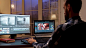 Back view of content creator working in home office during night time. video editor in home office.