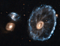 Cartwheel of Fortune 
Image Credit: ESA, NASA
Explanation: By chance, a collision of two galaxies has created a surprisingly recognizable shape on a cosmic scale, The Cartwheel Galaxy. The Cartwheel is part of a group of galaxies about 500 million light y