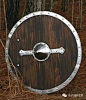 盾
尽管盾是一种防御装备，但是很多时候，对于维京人来说，盾的意义比武器还要重大。
唯一一种在维京人中广泛使用的防御装备便是盾牌。维京人使用一种由木头（一般是椴树，较为密实）制成的圆盾，这种圆盾中间放置把手的部分镀上了金属，既可以用来保护拿盾的手，也方便灵活地运用盾牌。有些盾牌则覆上了牛皮，甚至有的用金属的钉刺和边角加强了一番。一些另外的传奇中则提到盾牌看起来也分早期的轻巧型盾牌或者大方盾，这种盾有一个尖头，能覆盖住大部分腿部。