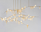 Multi-piece Cherry Bomb Fringe Chandelier installationin brushed brass with white and gold globes