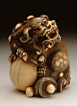 Chinese Lion Guarding the Jewel of the Buddha, 18th century  Netsuke, Ivory with staining, sumi, inlays: 