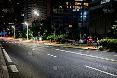 at night，City roads and modern office buildings in qingdao, China