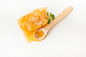 Honeycomb with herb and wooden spoon