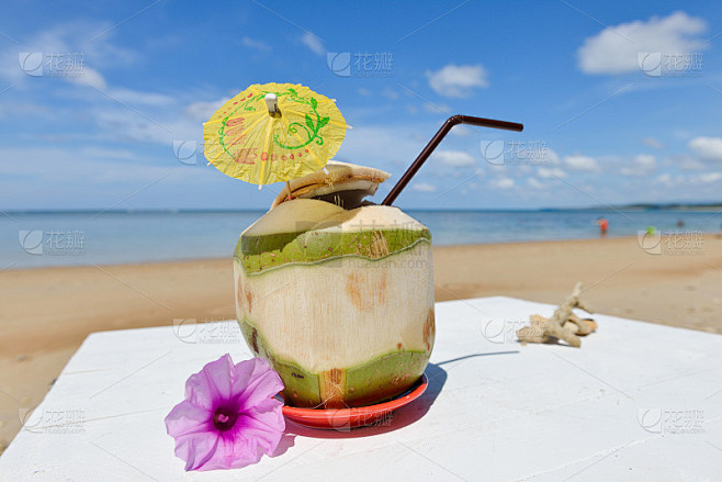 在海边用吸管喝椰子