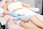Skillful young therapist is treating female body