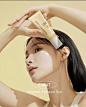 a woman holding her hair in front of her face with the sun shining on her