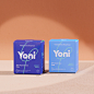 This may contain: two boxes of yoni are sitting on a counter top, one is blue and the other is purple