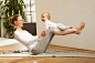 Woman balancing baby on her legs