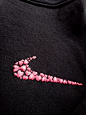 This may contain: a black sweatshirt with pink flowers on it