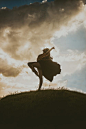 Woman Wearing Black Midi Dress Dancing on a Hill