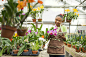 Black gardener using digital tablet in greenhouse by Gable Denims on 500px