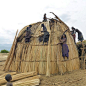 Africa |  Sights and Sounds.  Erbore women building a new house - Ethiopia by Eric Lafforgue: 