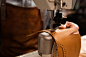 Close up of a shoemaker using sewing machine Free Photo