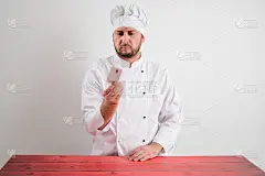 穿着白色制服的年轻男厨师出示名片
