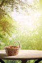 an empty basket sits on a table with trees in the background, in the style of flat backgrounds, ethereal foliage, chinapunk, playing with light and shadow, white background, dreamy and romantic, digitally enhanced