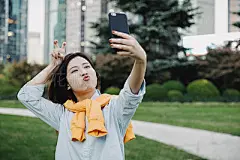 Beautiful Asian girl taking selfie with smart phone at park,Shanghai,ChinaChinese Ethnicity, Young Woman, Autumn,Using Smart Phone, Communication