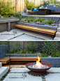 This backyard was transformed into a modern tiered garden with seating, a firebowl, a water feature, and stairs connecting the different levels. #ModernBackyard #ModernLandscaping #TieredBackyard