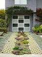 Creeping mint-filled pavers and succulents turn this working driveway into a green entryway in the Nash garden in the Castro neighborhood of S.F.
