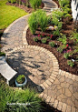 Small circle patio on a curved flagstone path. Love the border stones.