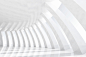 White arches tunnel in a empty architectural space with sunlight