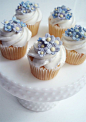 Forget-me-not cupcakes displayed on milk glass. Beautiful.