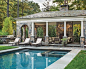This is an example of an expansive traditional rectangular swimming pool in New York with a pool house.