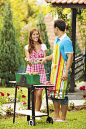 Young Couple Barbeque in a back yard.