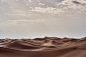 brown desert under white clouds