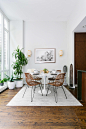 Example of a mid-sized trendy medium tone wood floor and brown floor dining room design in New York with white walls