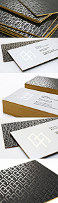 The design for these sleek business cards revolves entirely around the company logo.: 