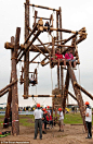 Look what we built: Scouts from around the world sit on an impressive gateway they built during the World Scout Jamboree in Sweden this year