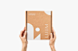 This may contain: two hands holding up a brown box with the word mum printed on it in white