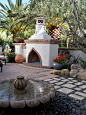 Mediterranean patio in Phoenix with with a fire feature.