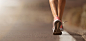 Running shoe closeup of woman running on road with sports shoes