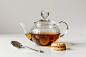 glass teapot on white surface, white background spoon, biscuit,


--ar 3:2