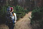 Shallow Focus on Blond Haired Woman in White Long Sleeve Shirt Carrying a Baby on Her Back