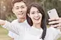 Happy young couple in love taking a selfie on phoneHappy young couple in love taking a selfie on phone