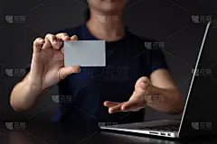 手拿名片，手提电脑。