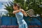 nice-girl-plays-tennis-court-outdoors-prepares-to-beat-off-ball-woman-wears-light-blue-sportswear-horizontal-sportive-119286742