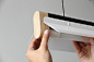 Tutuk Lamp : Tutuk is a very graphic looking lamp due to its simple and geometric shapes combined with neutral colors warmed by the touch of wood. This lamp gives a different look and feel to collective working spaces since most of the time, illumination 