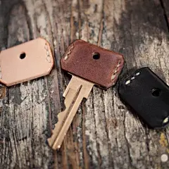 Buy small strips of leather and cut out key covers for all your keys, sew the sides and cut out a whole for the key ring.: 